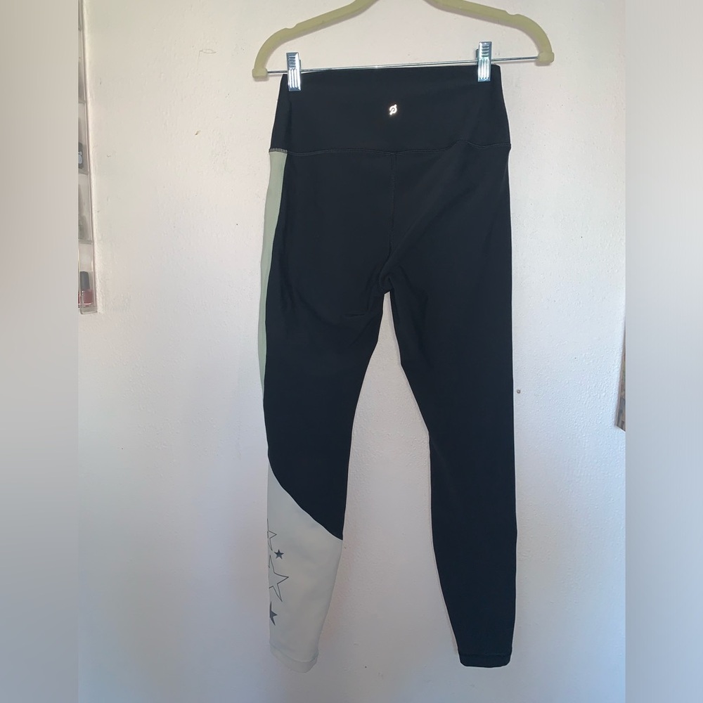 Peloton black leggings with silver stars.
